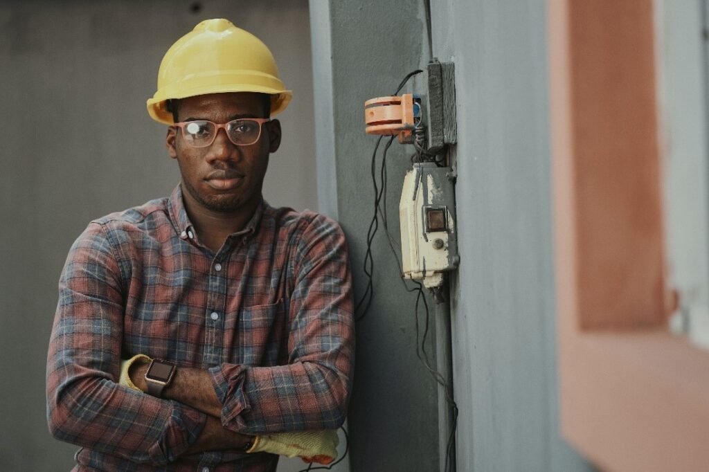 draughting certificates, man wearing yellow construction hat and glasses