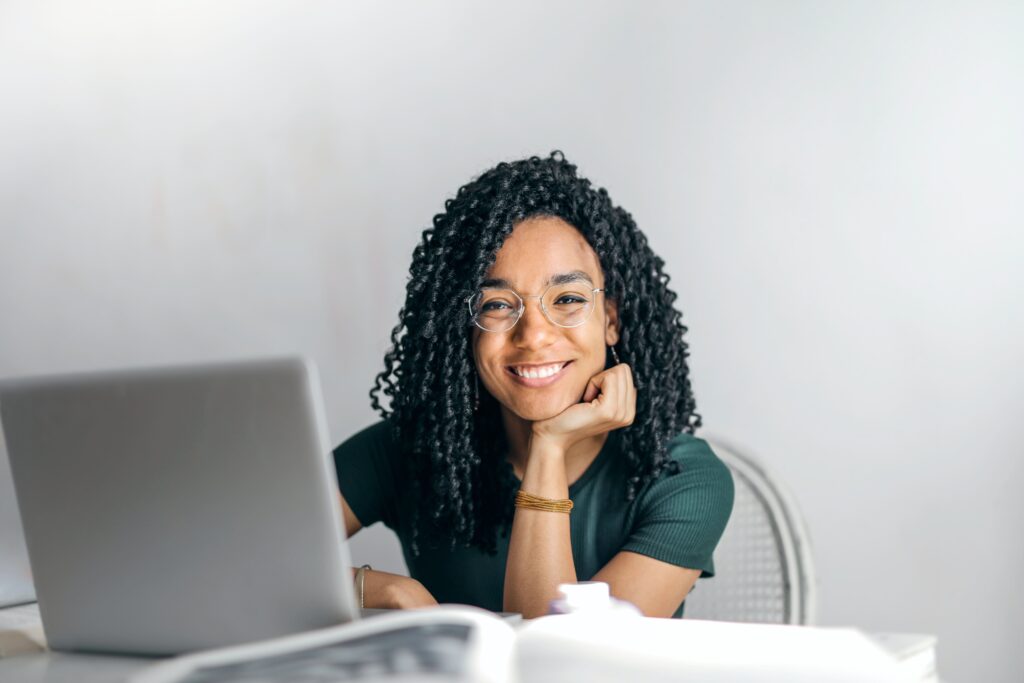 african female smiling using laptop
